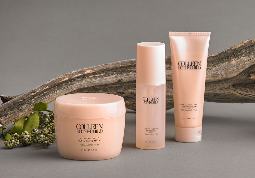 Hair care products in front of tree branch.