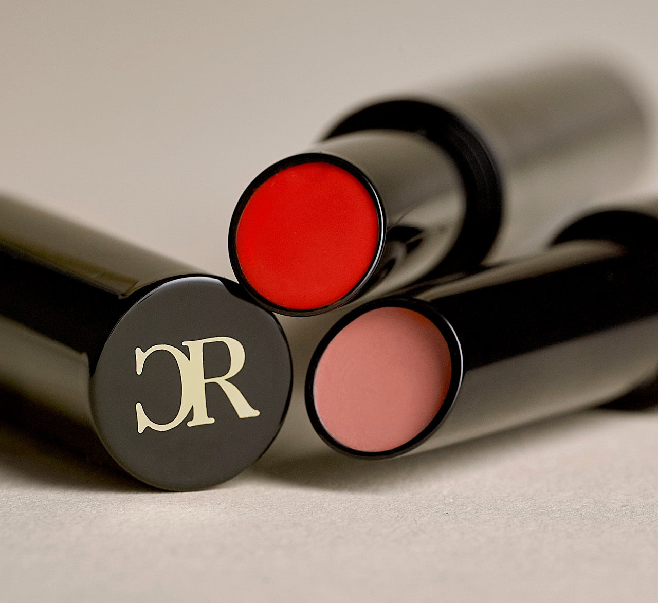 Close up of red and pink Hydrashine Lipstick Balms