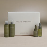 Colleen Rothschild hair renewal edit set featuring olive green bottles of shampoo, conditioner, and treatments arranged in front of a white product box on a neutral beige background.
