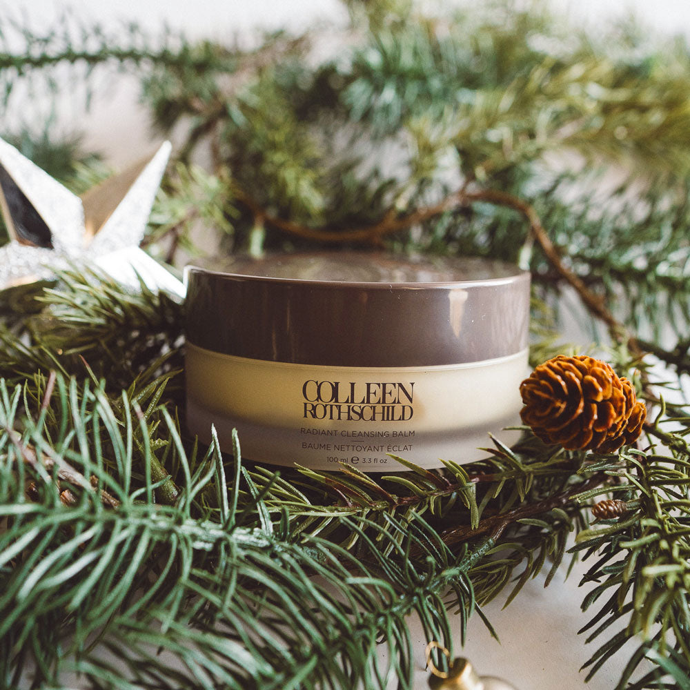 Radiant Cleansing Balm with holiday greenery and star ornament.