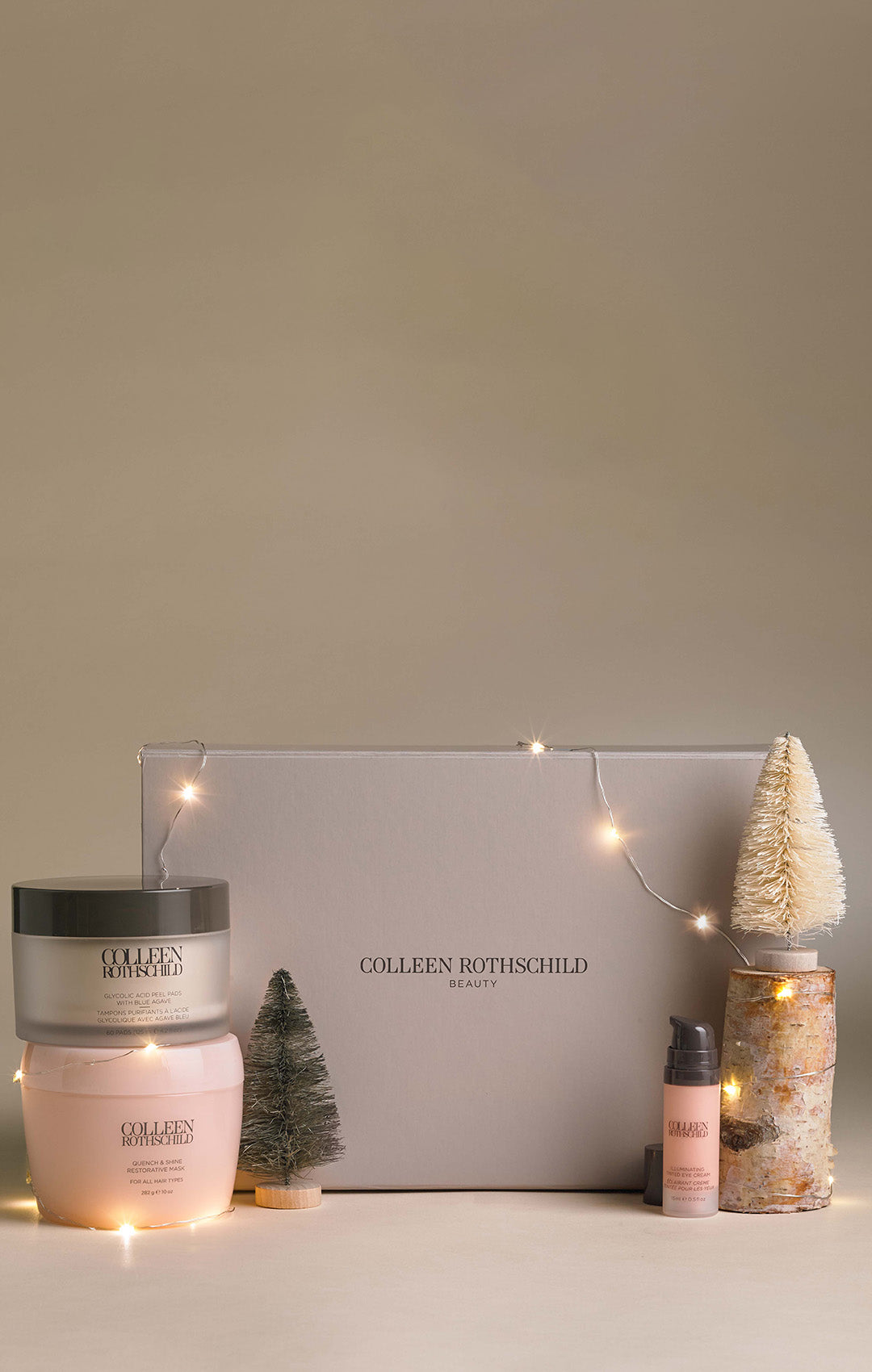 Colleen Rothschild Beauty holiday display with skincare products, mini trees, and string lights.