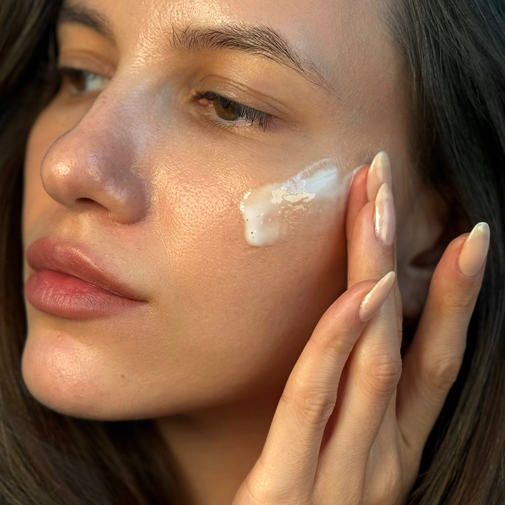 Moisture Veil Silk Emulsion being applied to woman's cheek