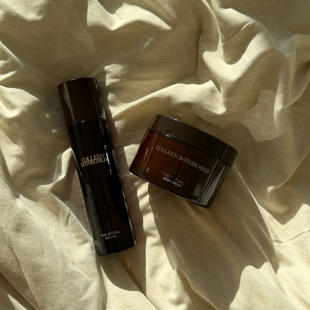 THE RITUAL Body Duo products lay flat on tan bedding