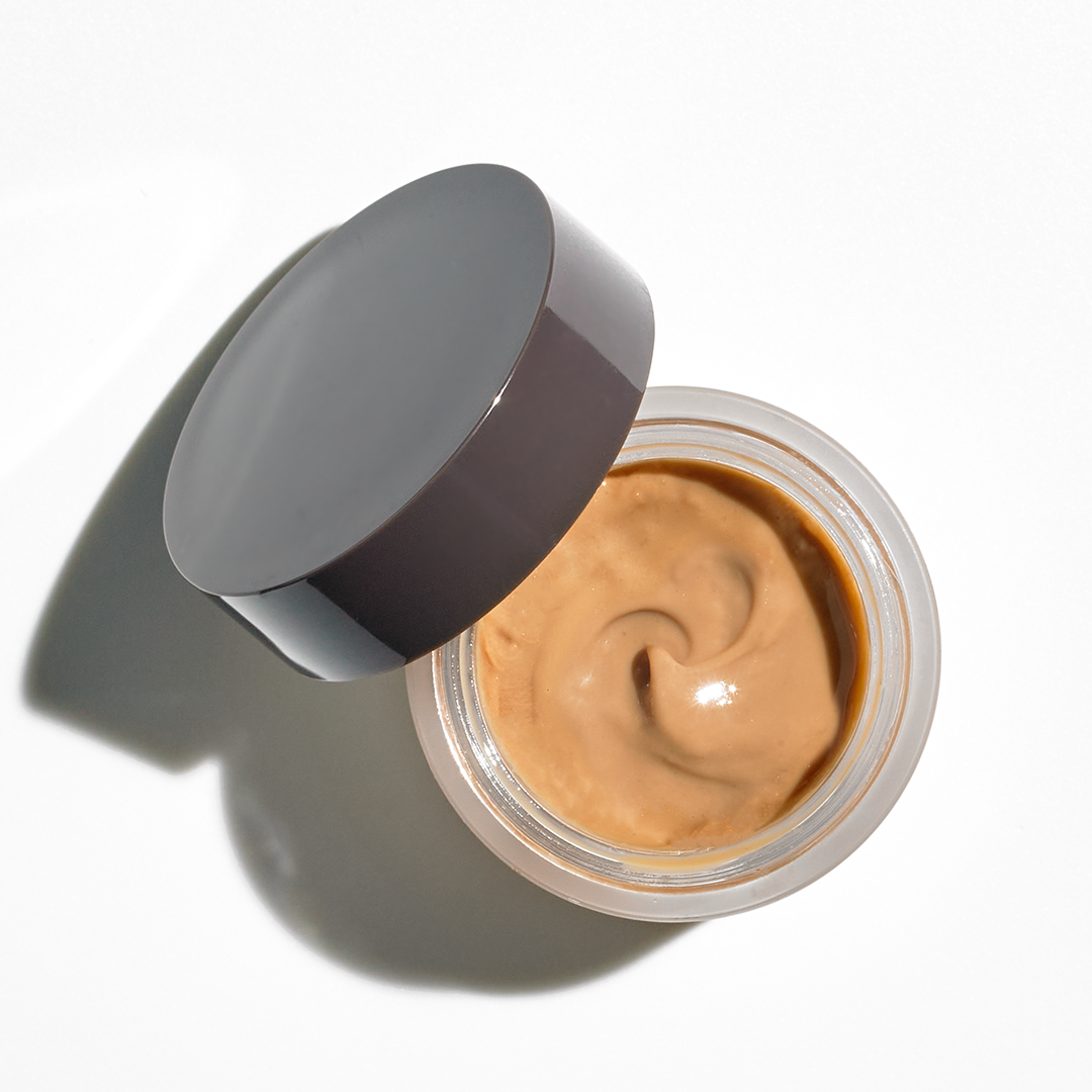 Overhead of brown creme in jar with brown lid